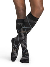 Sigvaris microfiber black knee-high socks with argyle pattern worn by a person on a white background