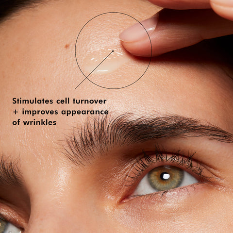 Close-up of a person's eye with skin care product application, highlighting effects on cell turnover and wrinkles.