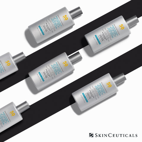 Four bottles of SkinCeuticals Sheer Sunscreen with SPF 50 are arranged diagonally on a white background with a bold black graphic stripe. The bottles are white with silver caps, featuring blue and yellow text on the labels.