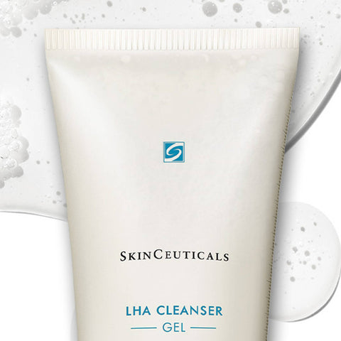 A squeeze tube of SkinCeuticals LHA Cleanser Gel, shown in a clean studio shot with decorative white foam and soap bubbles on a white background.