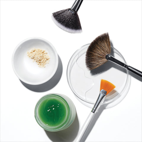 Makeup brushes and containers with SkinCeuticals Phyto Corrective Masque on a white background