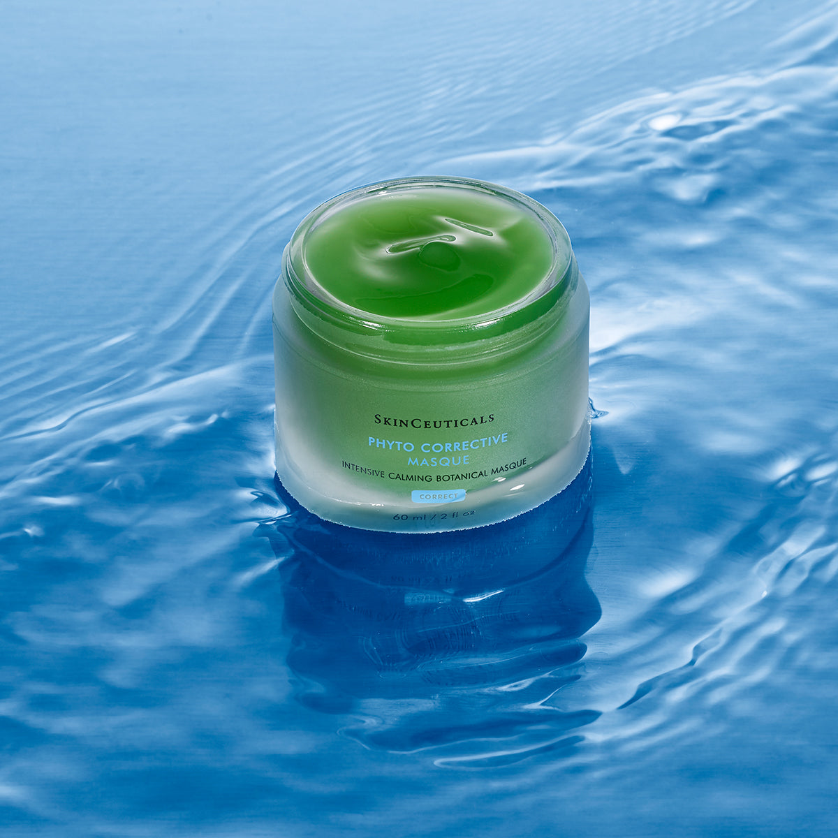 SkinCeuticals Phyto Corrective Masque jar on water with blue background