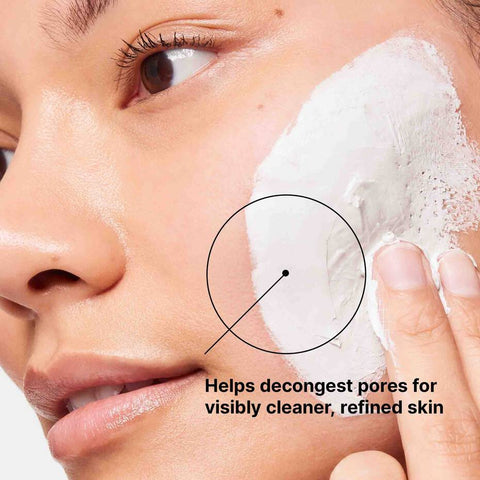 Person applying SkinCeuticals Clarifying Clay Masque with text highlighting pore-decongesting benefits.