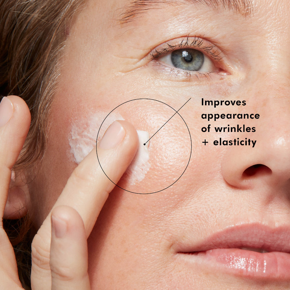 Close-up of a person applying SkinCeuticals A.G.E. Interrupter Advanced to their face with text highlighting skin improvement.