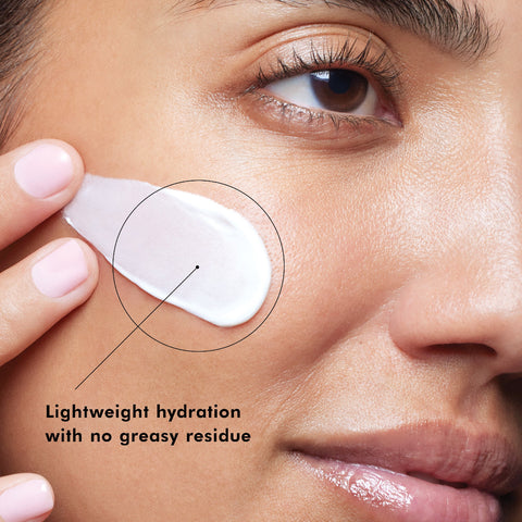 Close-up of a woman applying SkinCeuticals Daily Moisture to her face with text 'Lightweight hydration with no greasy residue'.