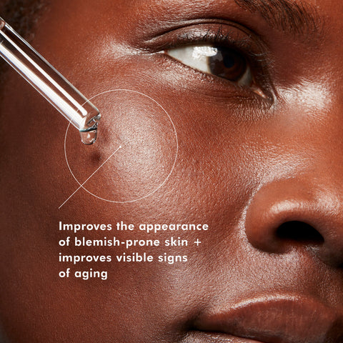 Close-up of a person's face with a dropper applying a product, text indicating benefits on skin.