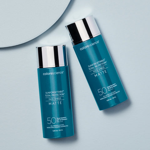 Two bottles of Colorescience sunscreen on a light gray background